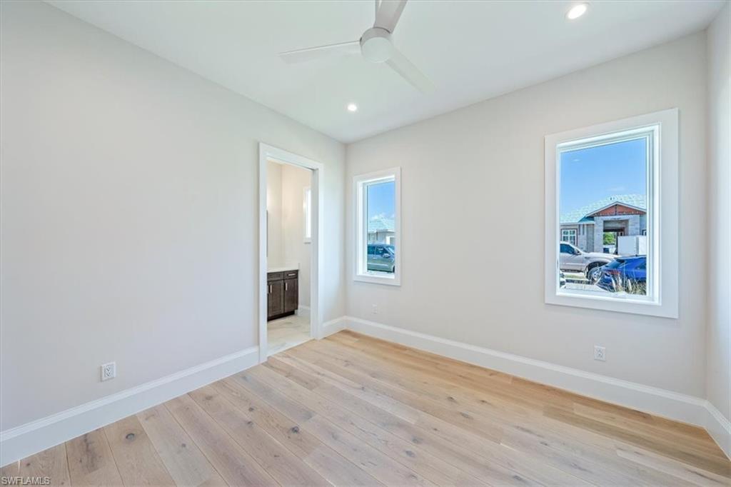 23511 Coconut Road Estero, FL 34134 - Photo 26 of 50 wooden floor in an empty room with a window