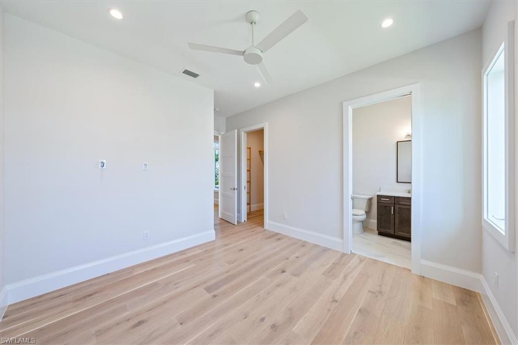23511 Coconut Road Estero, FL 34134 - Photo 27 of 50 wooden floor in an empty room with a window