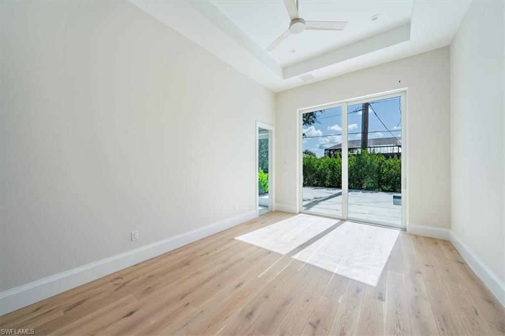 23511 Coconut Road Estero, FL 34134 - Photo 29 of 50 a view of an empty room with wooden floor and a window