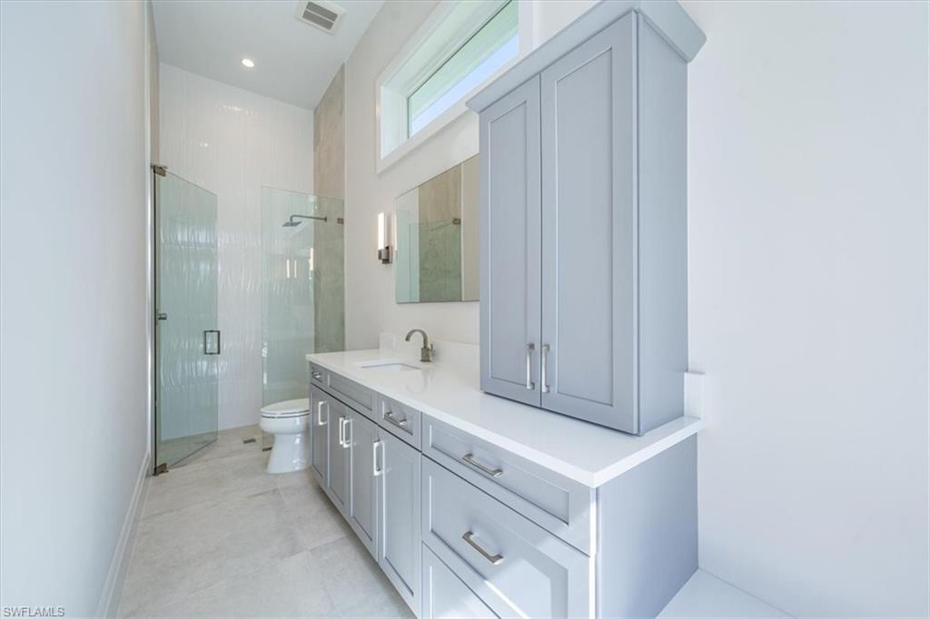 23511 Coconut Road Estero, FL 34134 - Photo 32 of 50 a bathroom with a sink a toilet and shower