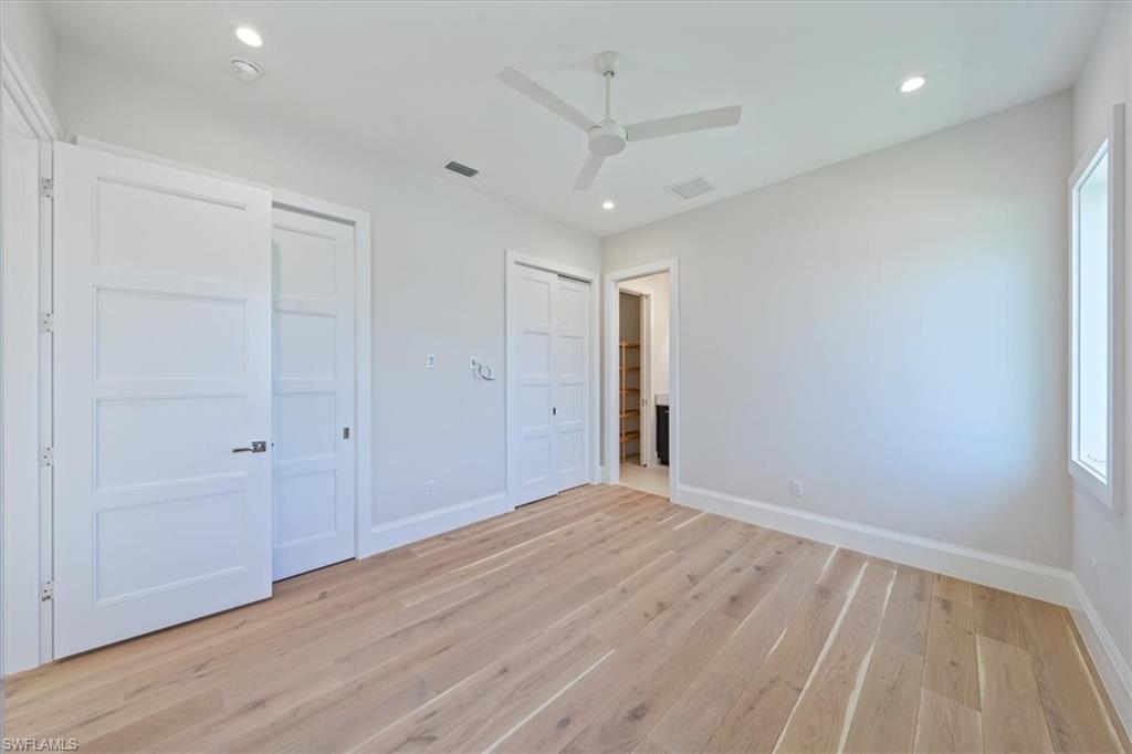 23511 Coconut Road Estero, FL 34134 - Photo 35 of 50 wooden floor in an empty room with a window