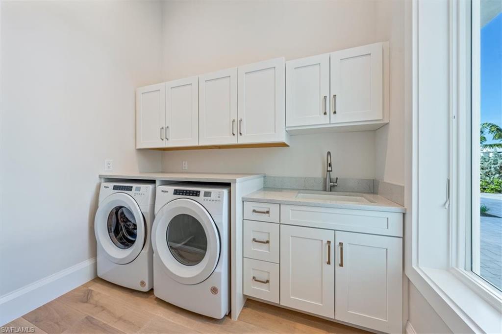 23511 Coconut Road Estero, FL 34134 - Photo 37 of 50 a utility room with sink dryer and washer