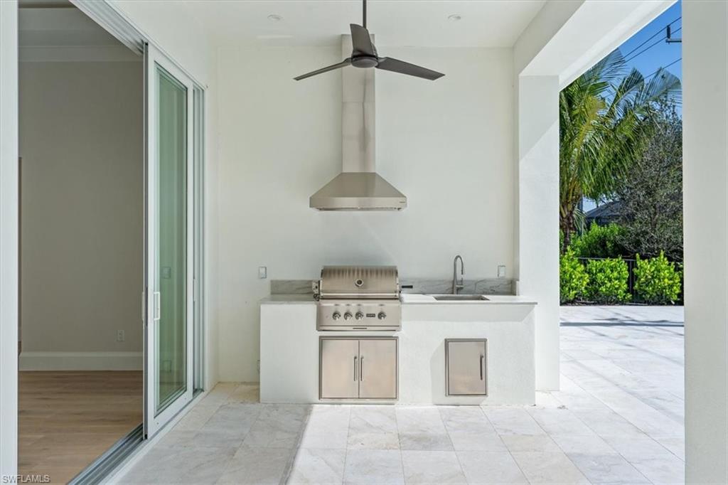 23511 Coconut Road Estero, FL 34134 - Photo 41 of 50 a kitchen with a stove and a chandelier