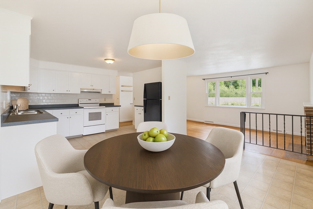 91 Old Post Road Sharon, MA 02067 - Photo 2 of 18 a living room with stainless steel appliances furniture a dining table and a kitchen view