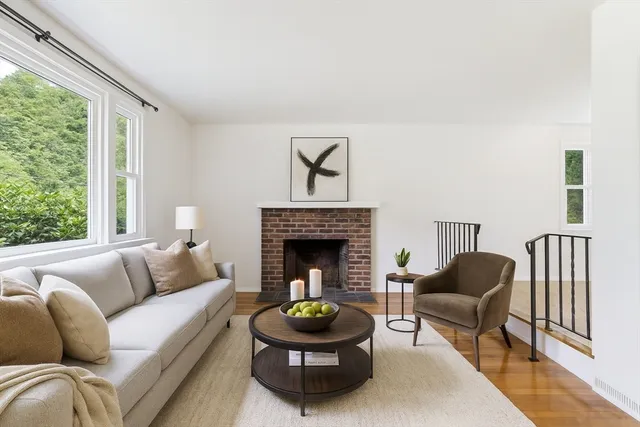 a living room with furniture a window and a fireplace