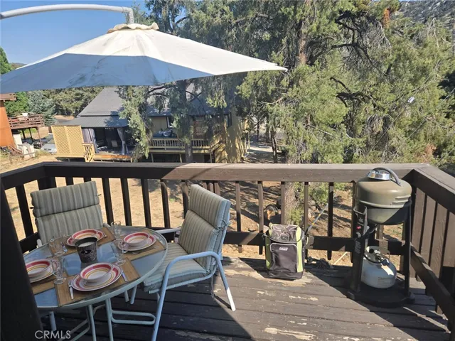 a view of a hallway with wooden floor and a bathroom