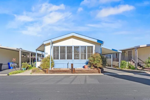 a view of house with outdoor space and sitting area