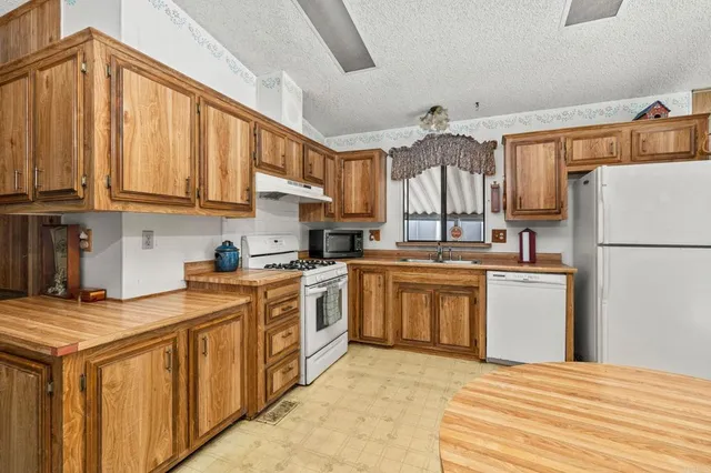 a view of a bedroom with furniture and window