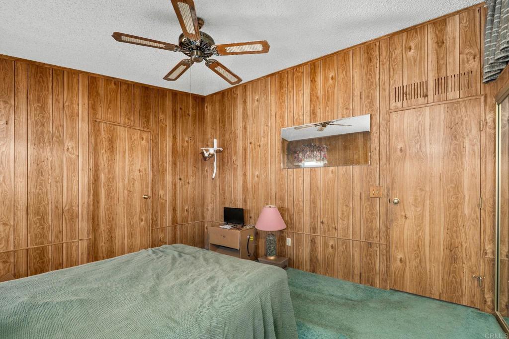 11949 Riverside Drive, Unit 23 Lakeside, CA 92040 - Photo 17 of 35 a bedroom with a bed and a table