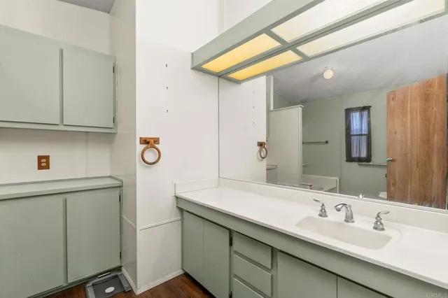 a bathroom with a tub a sink and a window