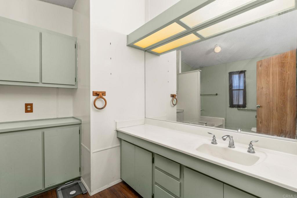 11949 Riverside Drive, Unit 23 Lakeside, CA 92040 - Photo 18 of 35 a bathroom with a sink a mirror and shower