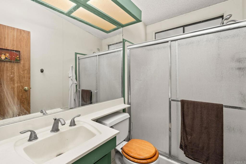 11949 Riverside Drive, Unit 23 Lakeside, CA 92040 - Photo 24 of 35 a bathroom with a sink a toilet and shower