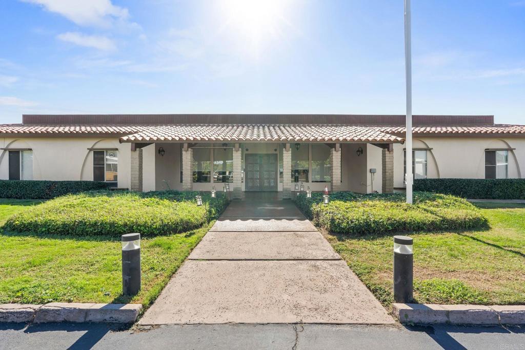 11949 Riverside Drive, Unit 23 Lakeside, CA 92040 - Photo 33 of 35 a front view of a house with a yard and potted plants