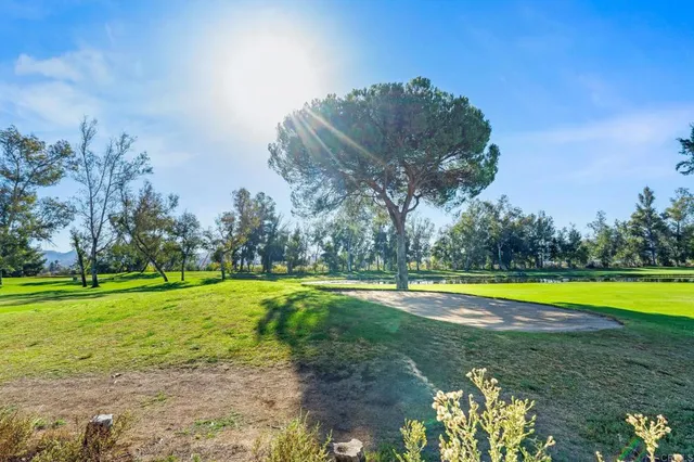 a view of a hallway with a dining table and chairs