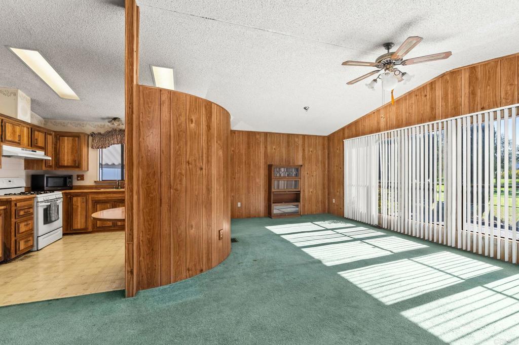 11949 Riverside Drive, Unit 23 Lakeside, CA 92040 - Photo 5 of 35 a view of a hallway with a dining table and chairs