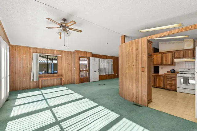 a view of a livingroom with a hall and a ceiling fan