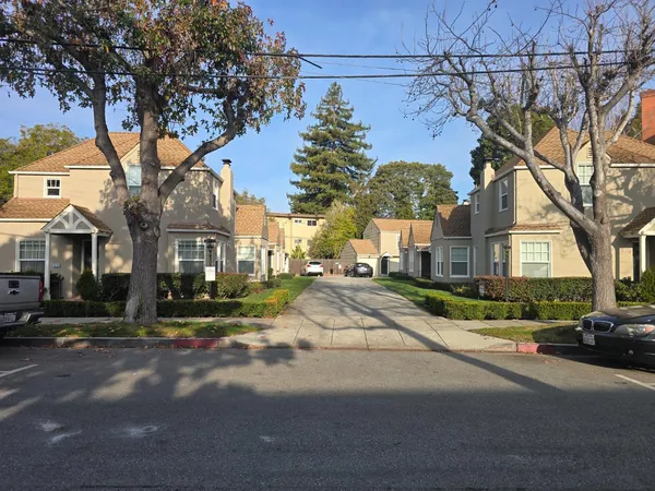 a view of a street with houses on the side