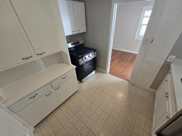 a kitchen with white cabinets