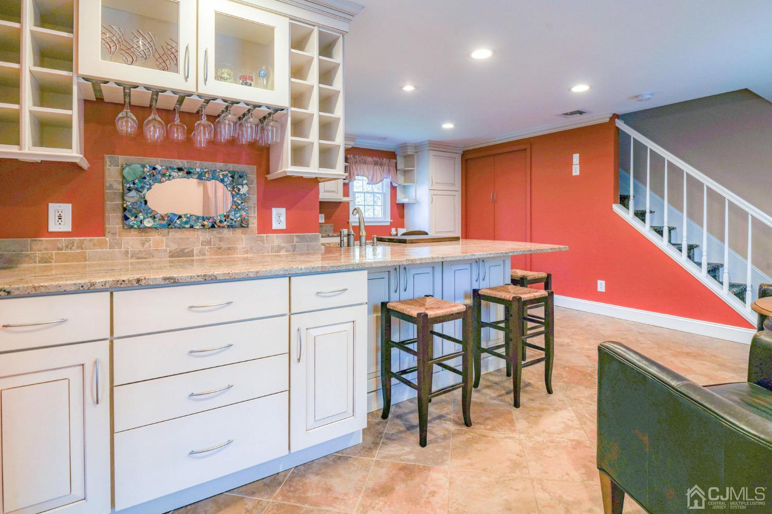 77 1st Street Edison, NJ 08837 - Photo 14 of 50 a kitchen with stainless steel appliances kitchen island granite countertop a table and chairs in it