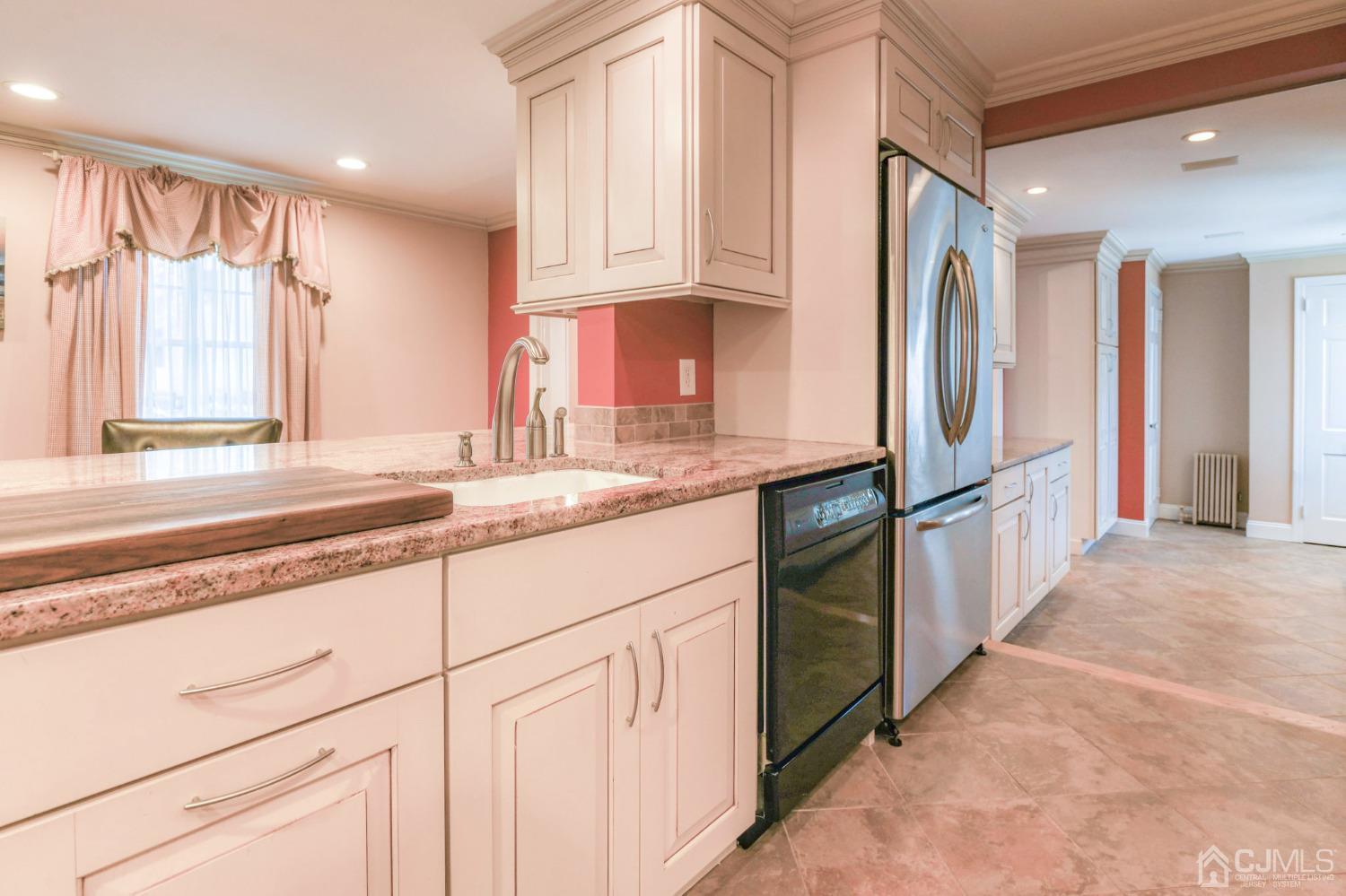 77 1st Street Edison, NJ 08837 - Photo 17 of 50 a kitchen with stainless steel appliances granite countertop a refrigerator and a sink