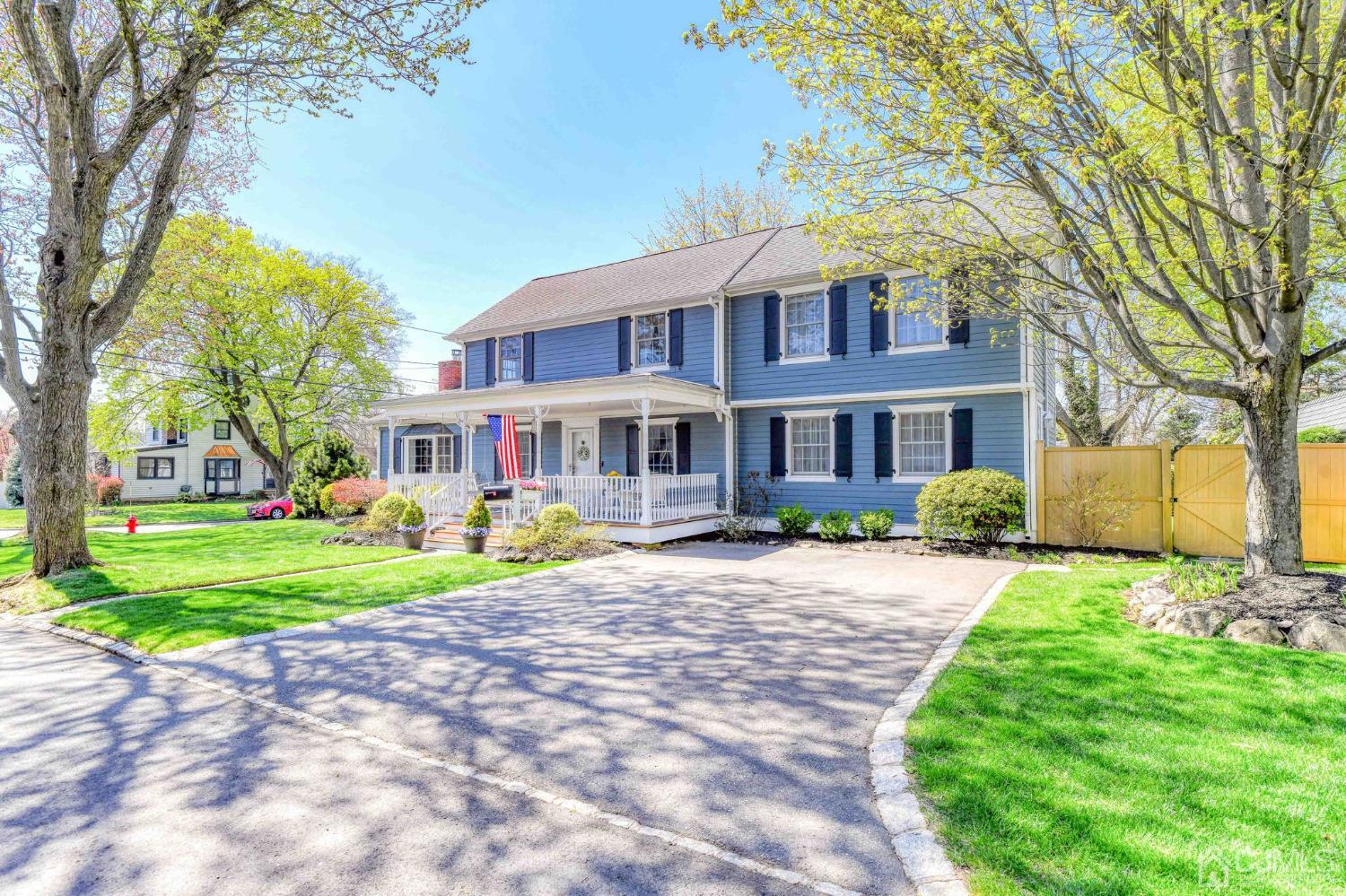 77 1st Street Edison, NJ 08837 - Photo 3 of 50 a front view of a house with a yard and trees