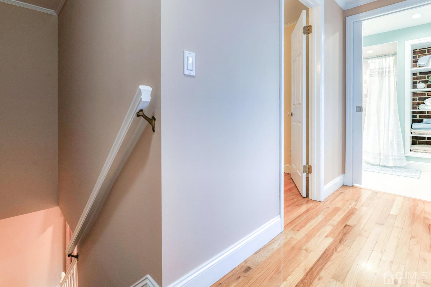 77 1st Street Edison, NJ 08837 - Photo 33 of 50 a view of a hallway with wooden floor and staircase