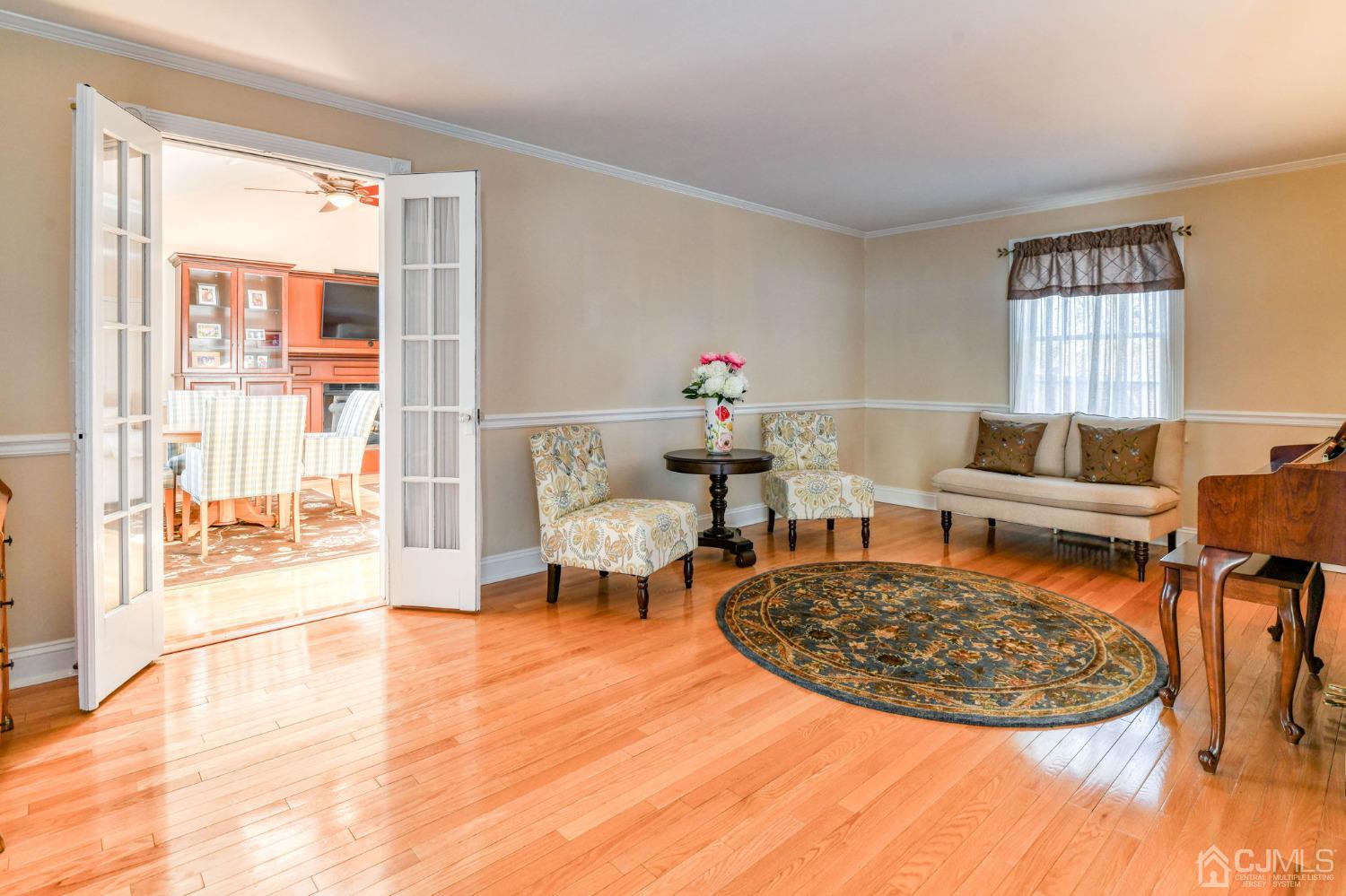 77 1st Street Edison, NJ 08837 - Photo 5 of 50 a living room with furniture a rug and a table