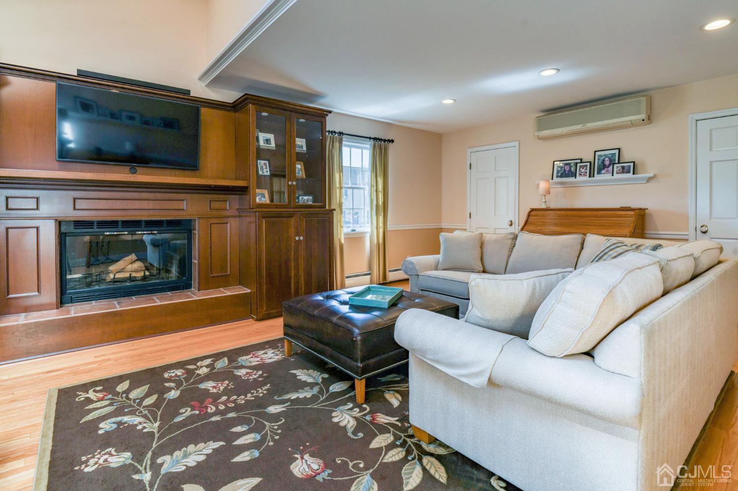 77 1st Street Edison, NJ 08837 - Photo 9 of 50 a living room with furniture and a fireplace