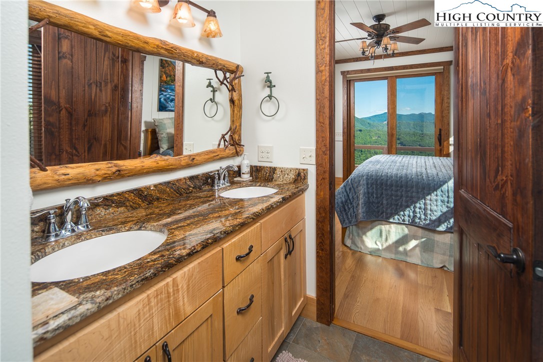 421 Chappell Farm Road Banner Elk, NC 28604 - Photo 20 of 49 a bathroom with a granite countertop sink and a mirror