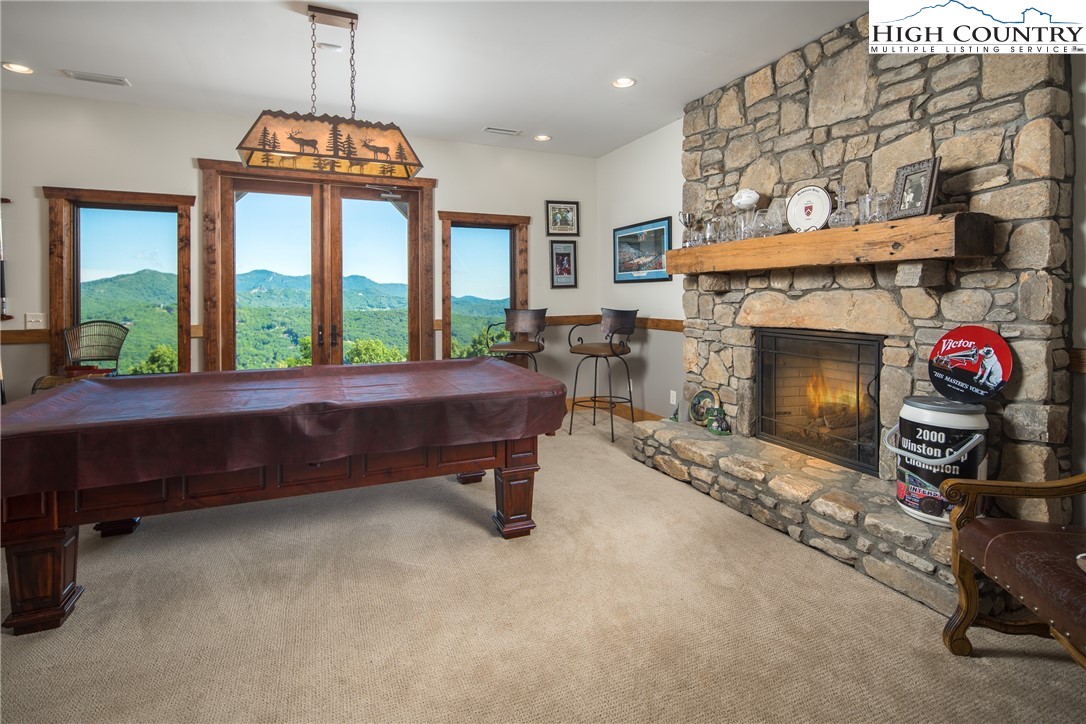 421 Chappell Farm Road Banner Elk, NC 28604 - Photo 31 of 49 a room with fireplace furniture and a large window