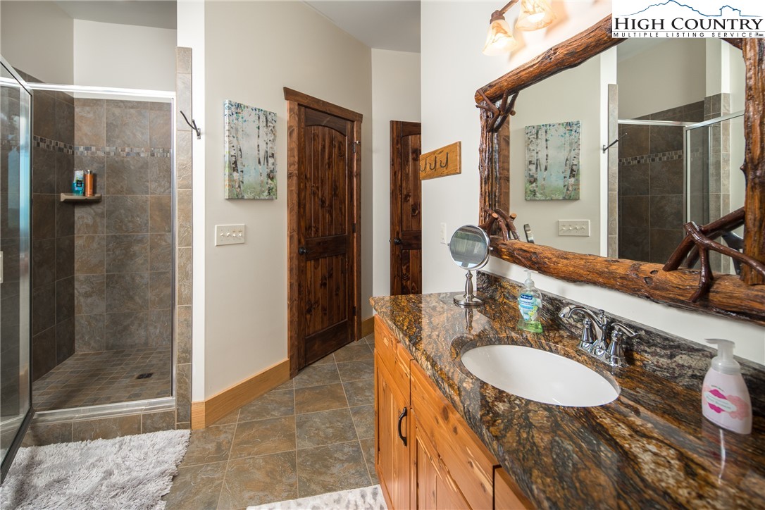 421 Chappell Farm Road Banner Elk, NC 28604 - Photo 34 of 49 a bathroom with a granite countertop shower sink and mirror