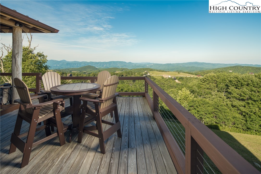 421 Chappell Farm Road Banner Elk, NC 28604 - Photo 5 of 49 a view of a balcony with mountain view and wooden floor