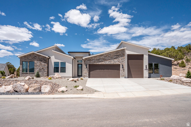 Modern facade featuring a combination of stucco and stacked stone accents