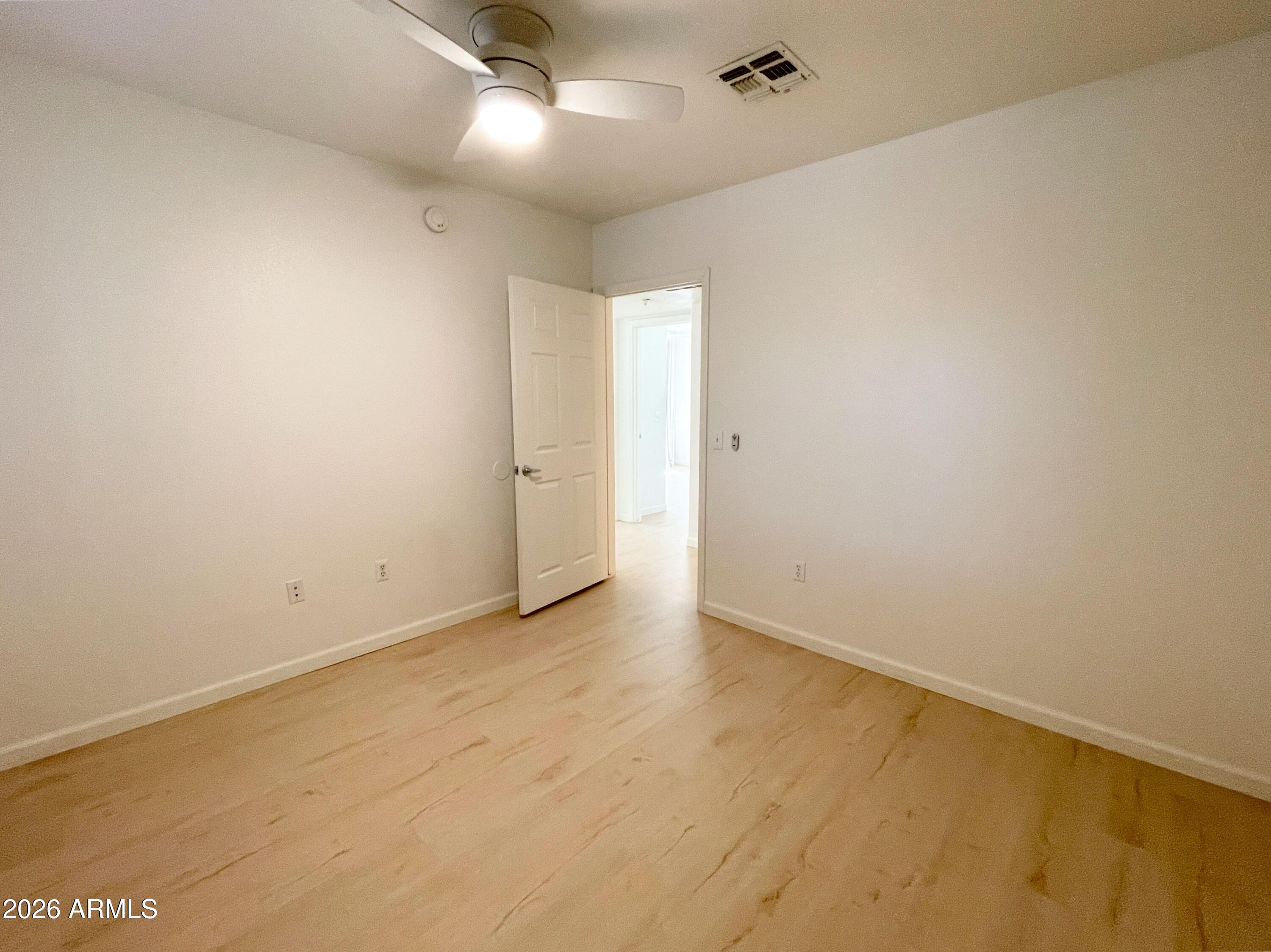 1295 North Ash Street, Unit 828 Gilbert, AZ 85233 - Photo 17 of 24 an empty room with a empty space and a ceiling fan