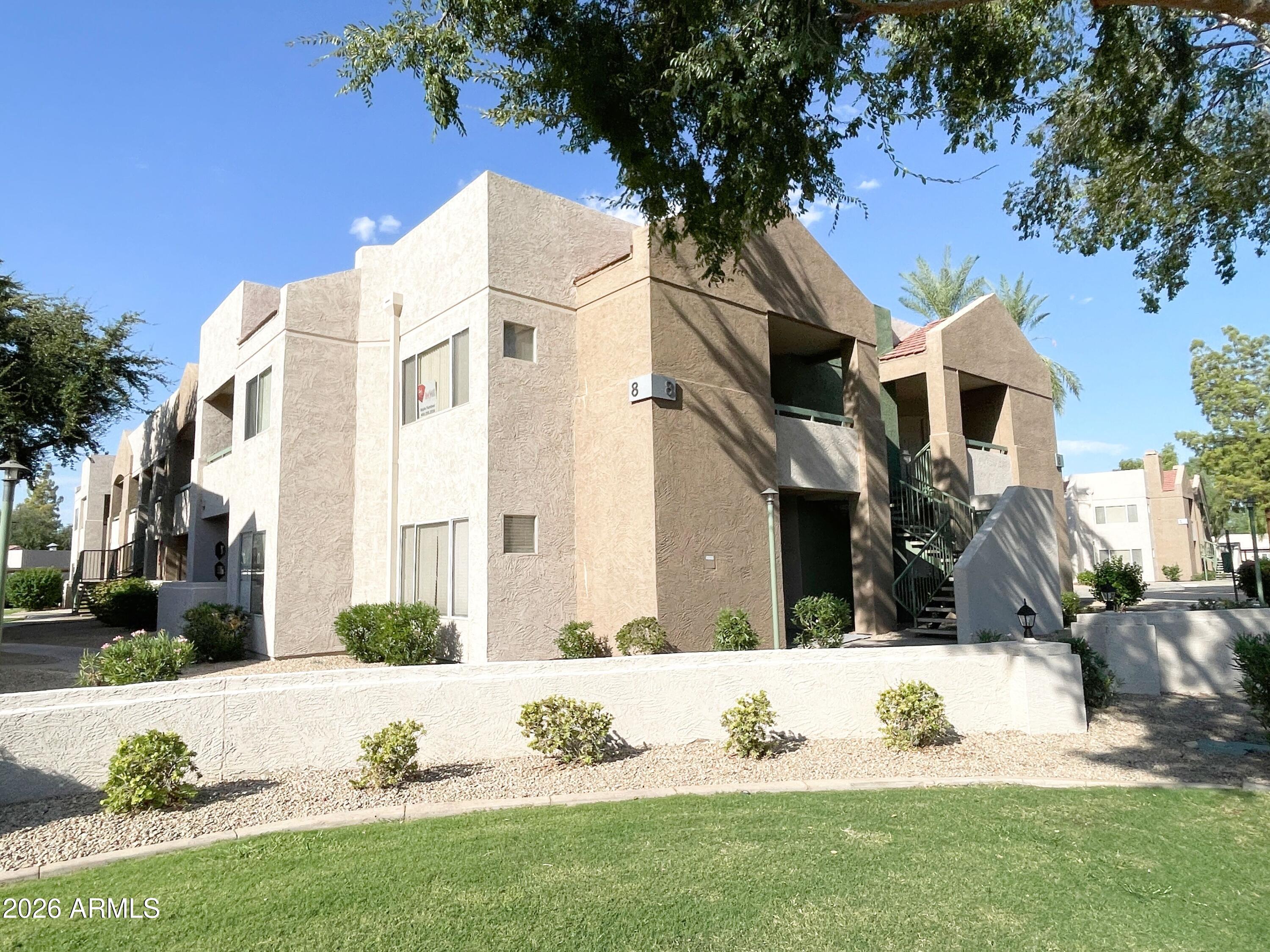 1295 North Ash Street, Unit 828 Gilbert, AZ 85233 - Photo 2 of 24 a view of a white house with a yard