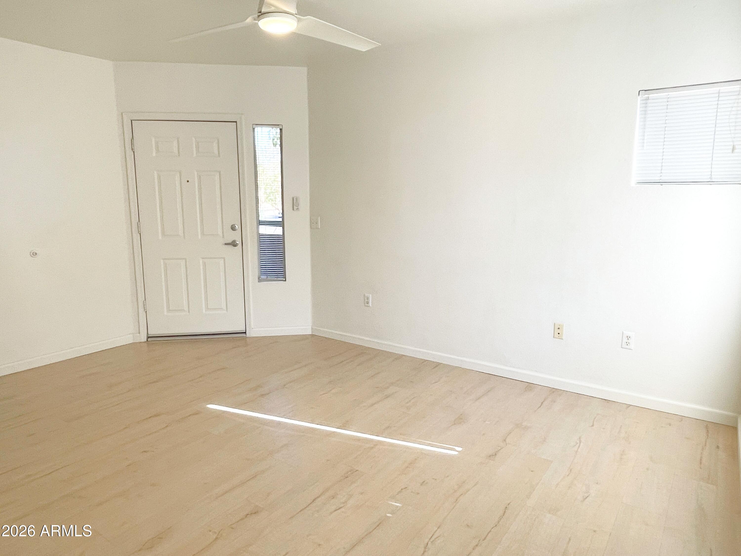 1295 North Ash Street, Unit 828 Gilbert, AZ 85233 - Photo 3 of 24 an empty room with a empty space and a window