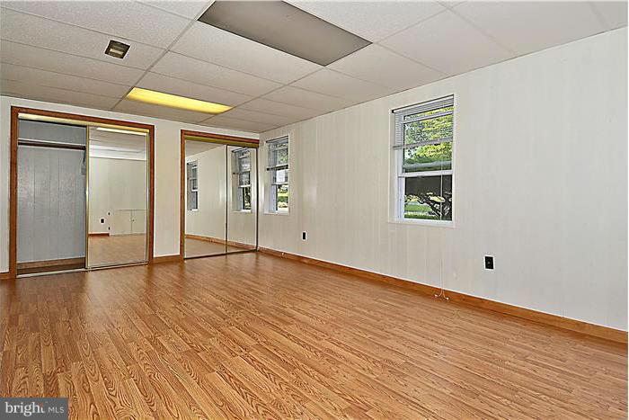 6716 Garrett Road Derwood, MD 20855 - Photo 22 of 30 a view of empty room with wooden floor and fan