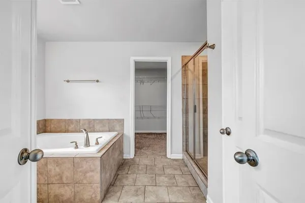 a bathroom with a bathtub and shower