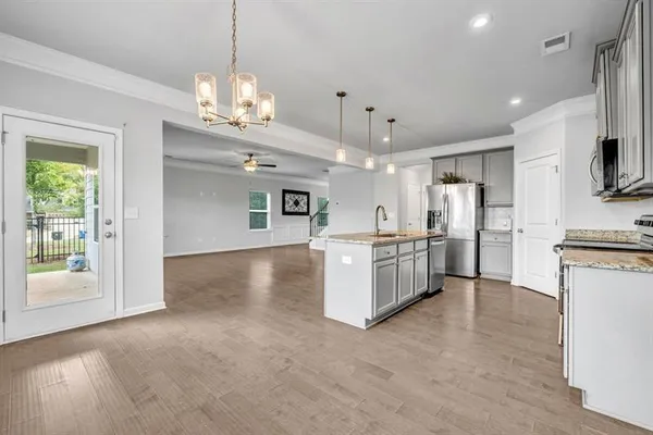 a view of kitchen with refrigerator and microwave