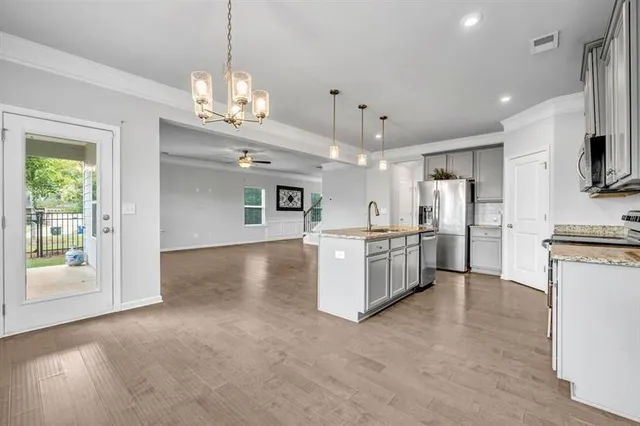 a view of kitchen with refrigerator and microwave