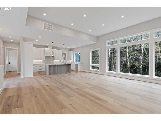 a view of an empty room with a kitchen