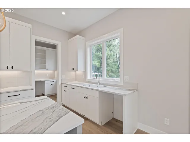a kitchen with appliances cabinets and a sink