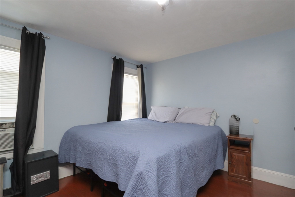 34 Preston Street Springfield, MA 01109 - Photo 17 of 34 a bedroom with a bed and a flat tv screen on a dresser