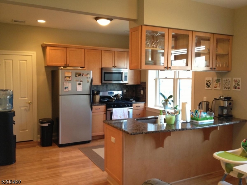 28 Gates Avenue, Unit A Summit, NJ 07901 - Photo 2 of 8 a kitchen with stainless steel appliances a refrigerator a stove a sink and a cabinets