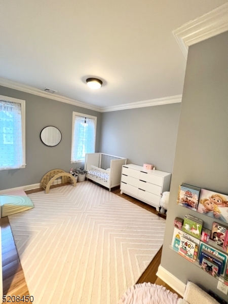 28 Gates Avenue, Unit A Summit, NJ 07901 - Photo 6 of 8 a bedroom with a bed and a dresser