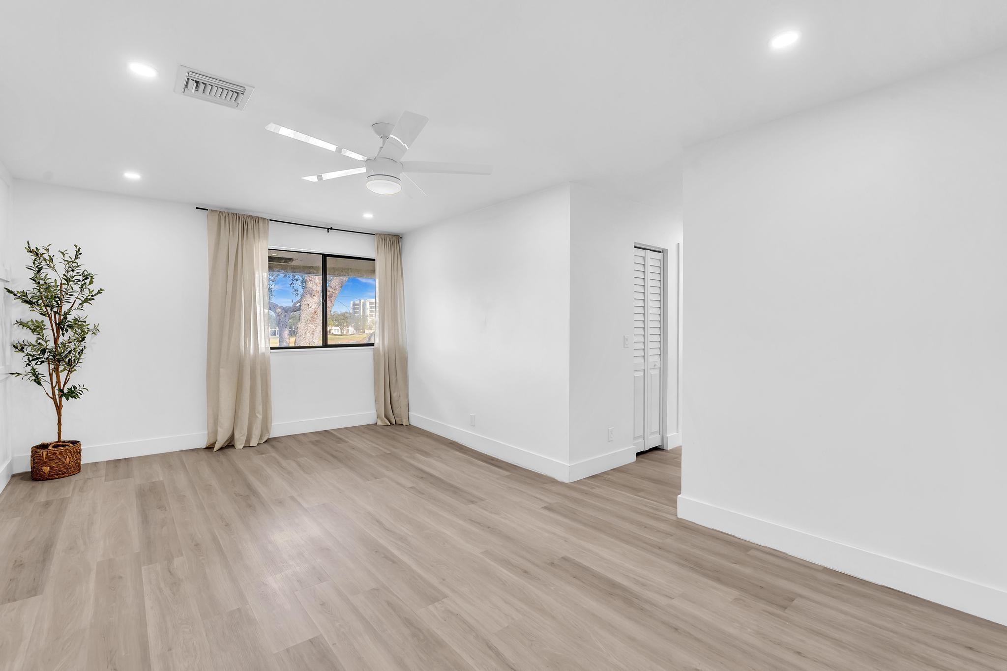 6565 Parkview Drive, Unit C Boca Raton, FL 33433 - Photo 14 of 40 an empty room with wooden floor and windows