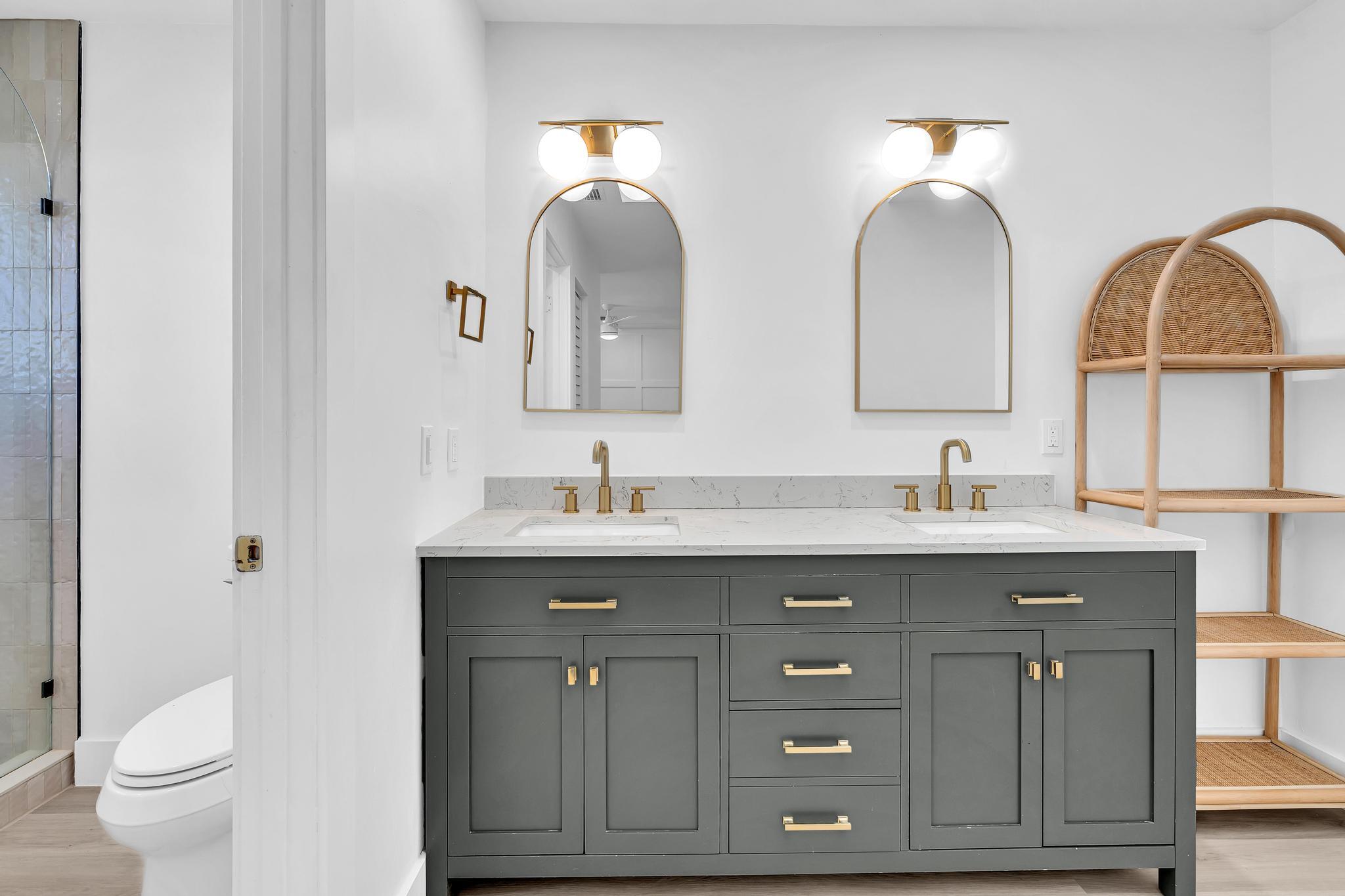 6565 Parkview Drive, Unit C Boca Raton, FL 33433 - Photo 15 of 40 a bathroom with a double vanity sink and a toilet