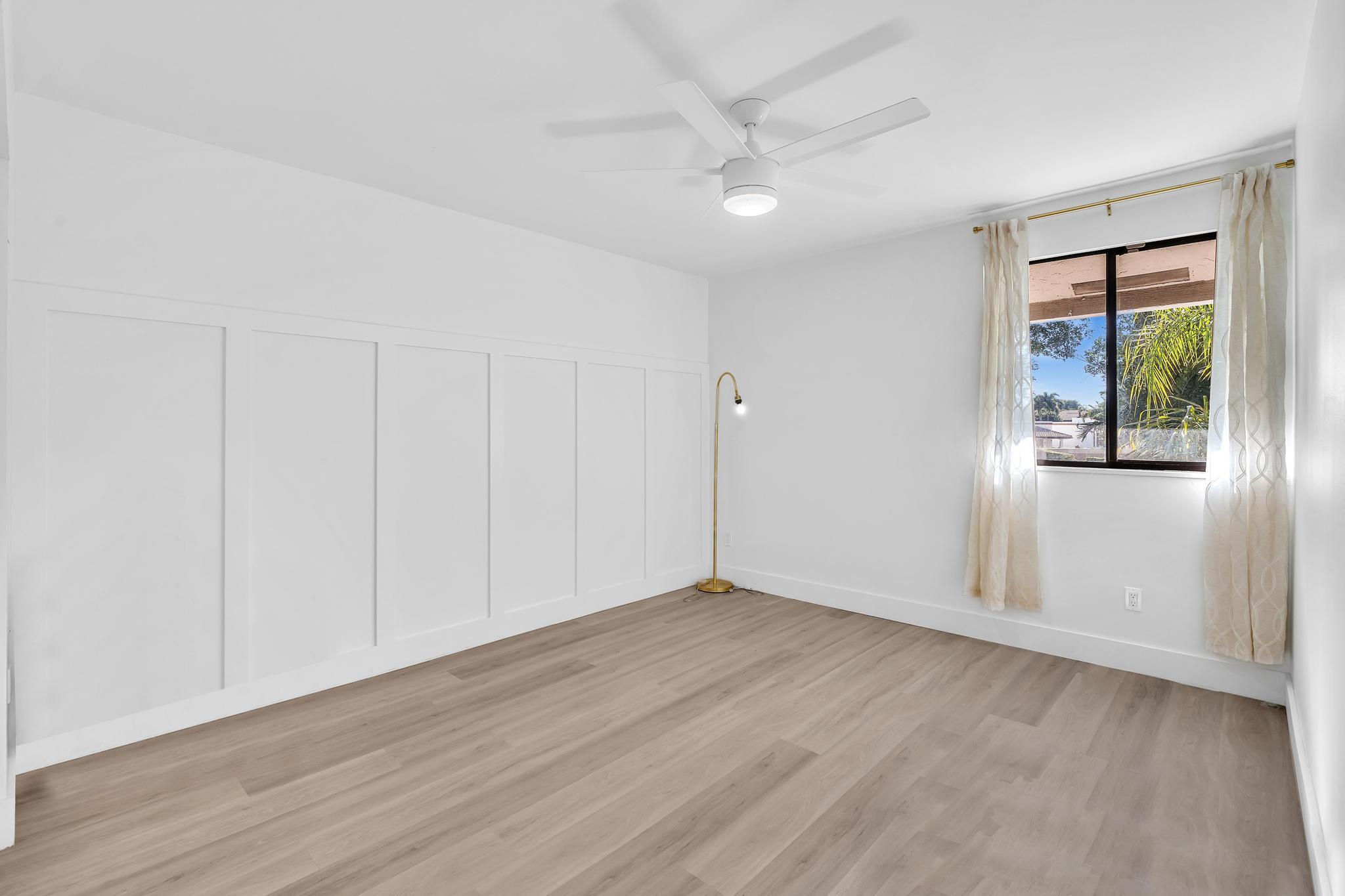 6565 Parkview Drive, Unit C Boca Raton, FL 33433 - Photo 18 of 40 a view of an empty room with wooden floor and a window