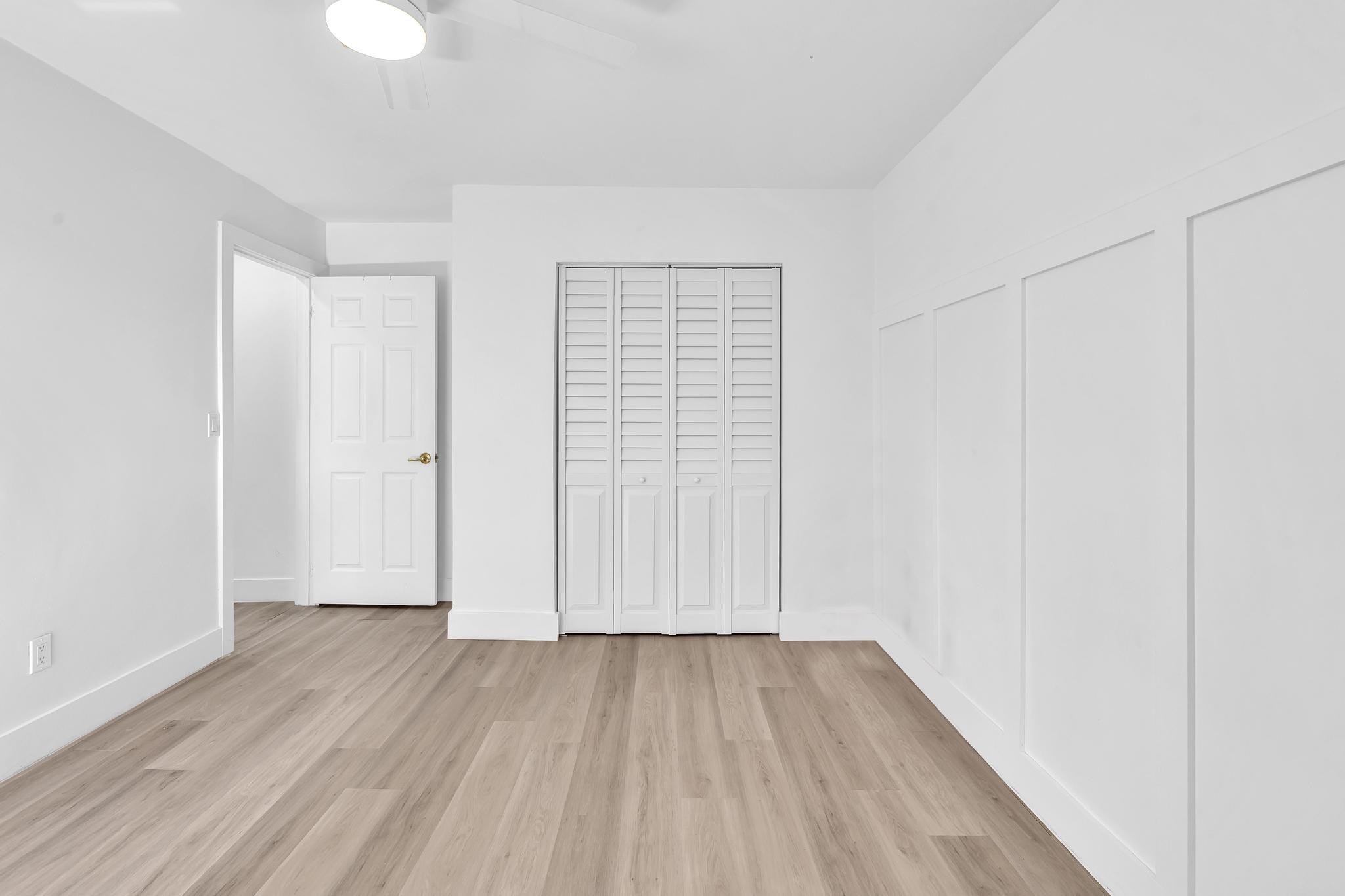 6565 Parkview Drive, Unit C Boca Raton, FL 33433 - Photo 19 of 40 an empty room with wooden floor