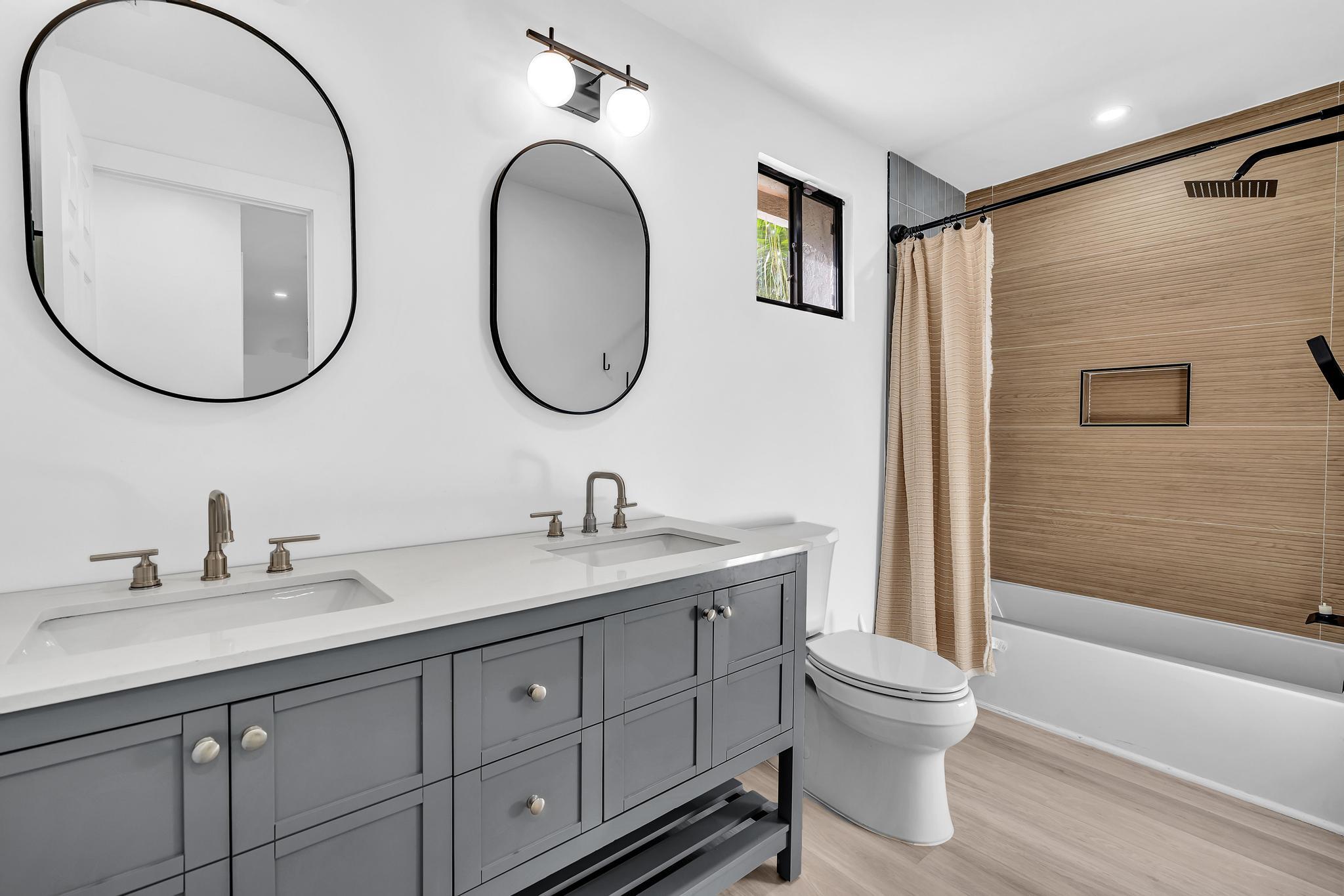 6565 Parkview Drive, Unit C Boca Raton, FL 33433 - Photo 20 of 40 a bathroom with a toilet a sink and a mirror